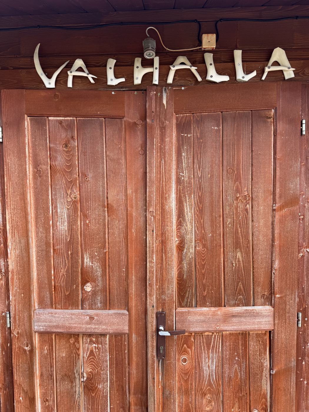 Hand-carved wooden door reading Valhalla